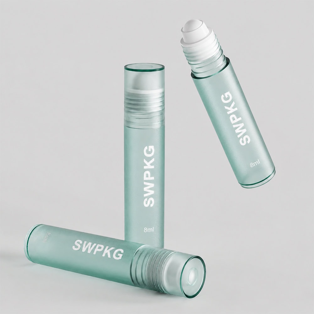 Small transparent plastic roll-on bottles for perfume with white caps.