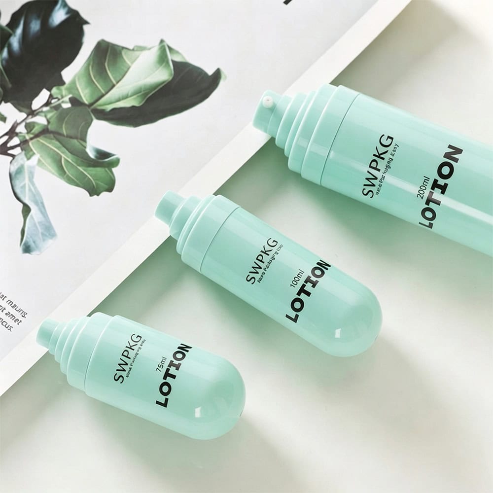 Three light green plastic lotion bottles with pump tops on a white surface.