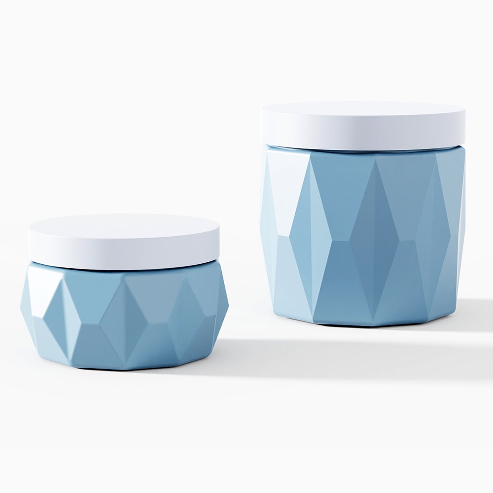 Blue geometric cosmetic jars with white lids for skin care products.