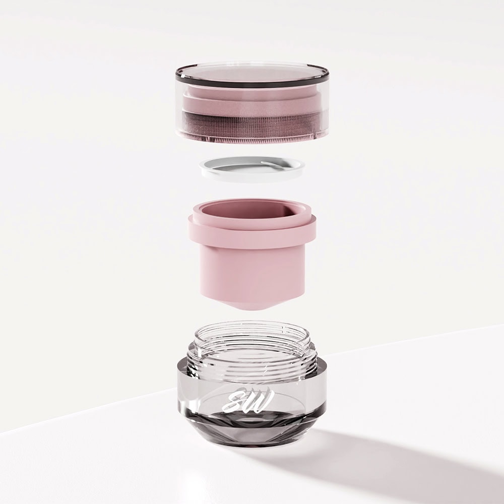 Disassembled luxury cosmetic jar showing layers and lid in pink and black.