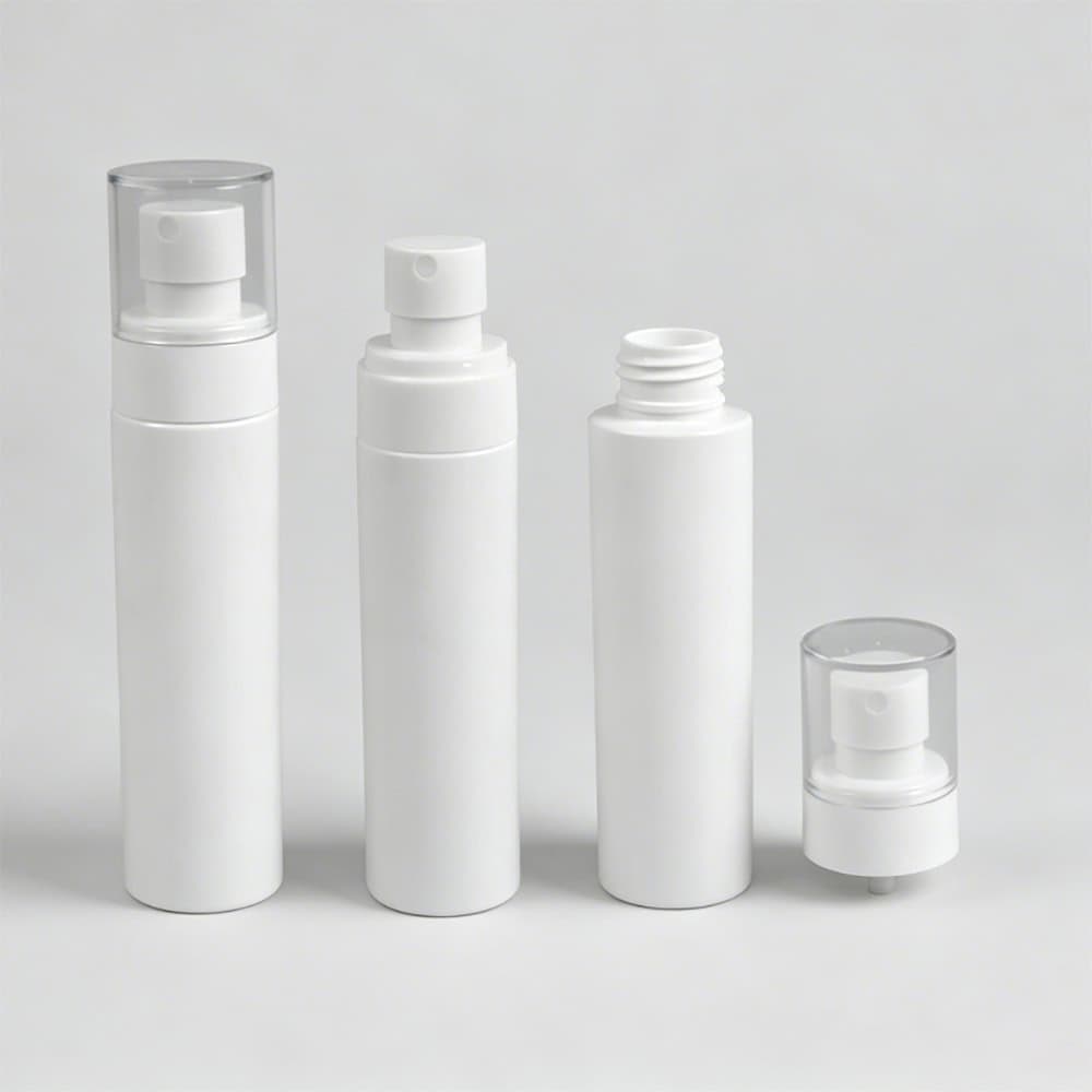 Set of glossy white plastic spray bottles with transparent caps for cosmetics.