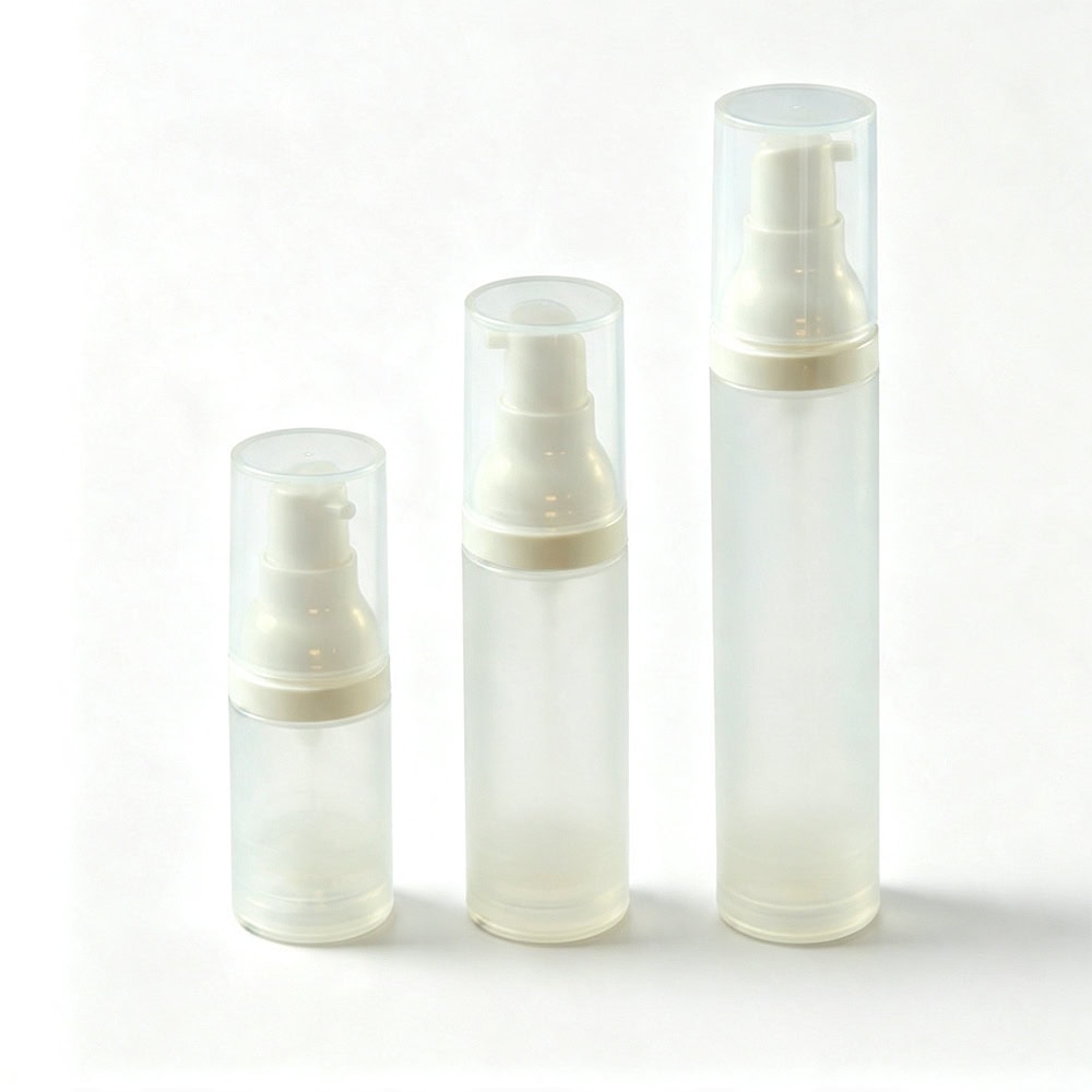 Three frosted plastic airless pump bottles in different sizes for skincare products.