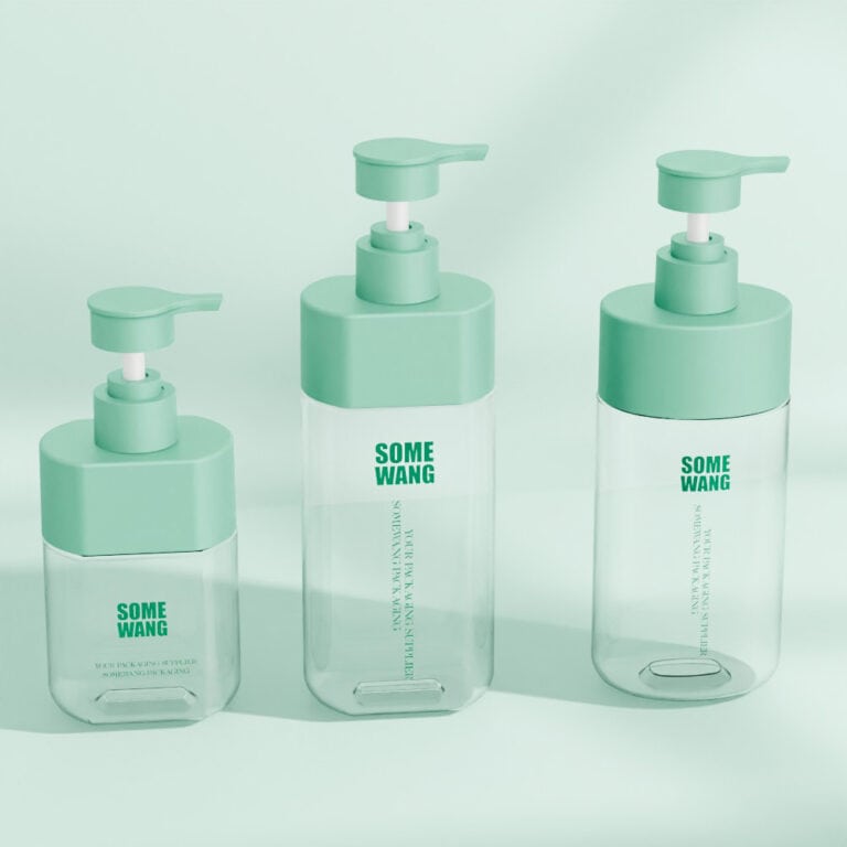 Set of three transparent lotion bottles with mint green pump caps.