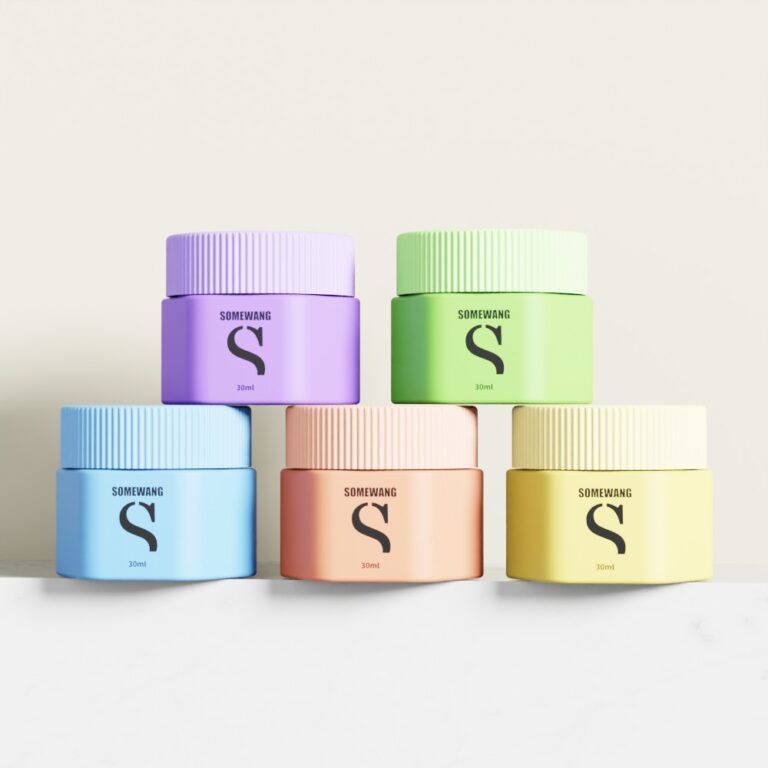 Set of five colorful 30g plastic cream jars with lids for cosmetics.
