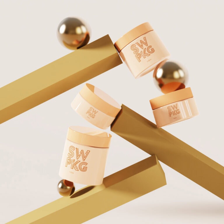 Elegant peach-colored facial cream jars with screw tops and logo design.