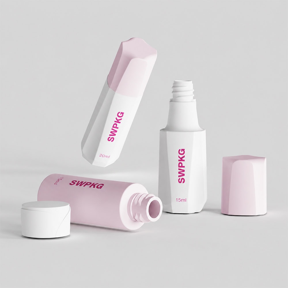 Travel skincare bottles with pink caps and white bodies for packaging.
