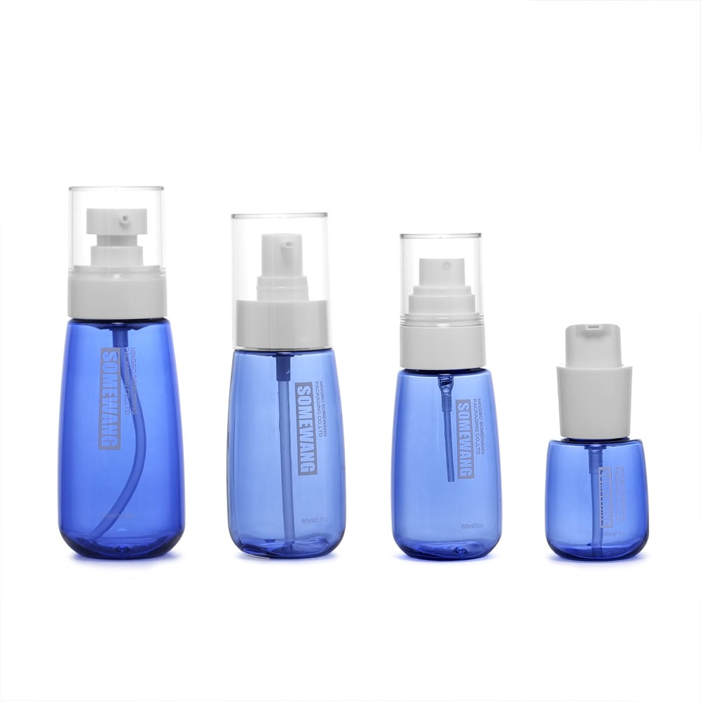 Set of four blue PETG plastic bottles with pump spray caps for packaging.