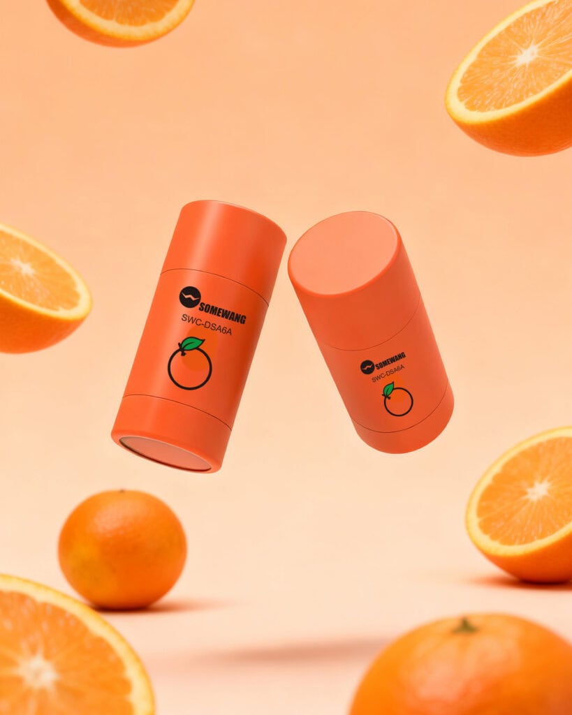Eco-friendly orange packaging containers with citrus fruits background.