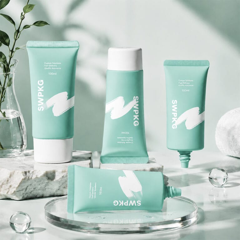 Set of four turquoise cosmetic tubes with white caps and branding.
