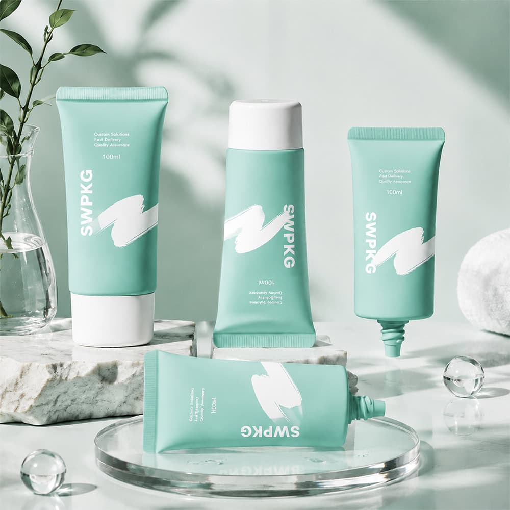 Set of four turquoise cosmetic tubes with white caps and branding.