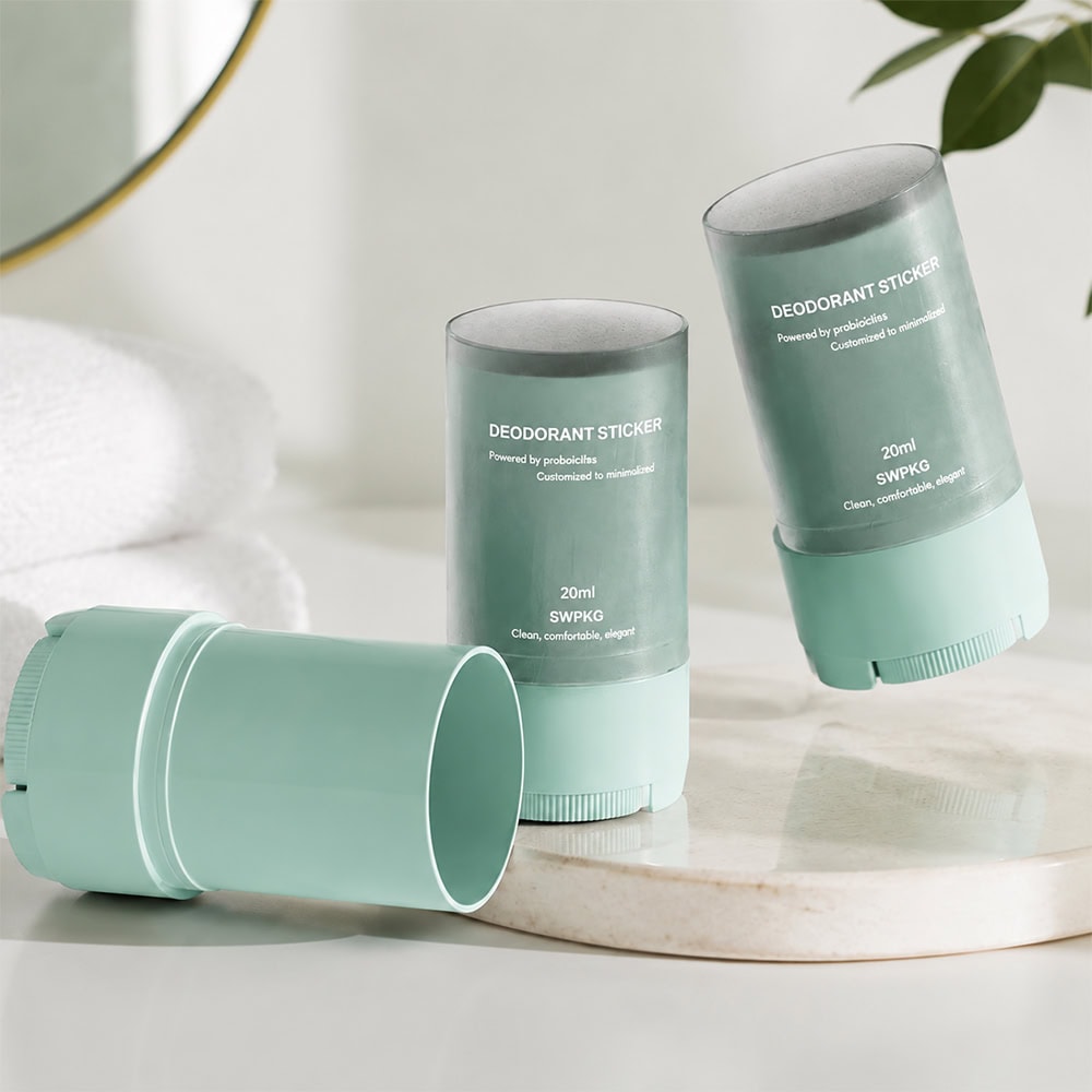 Three pastel green deodorant sticks with clear labels on a white surface.