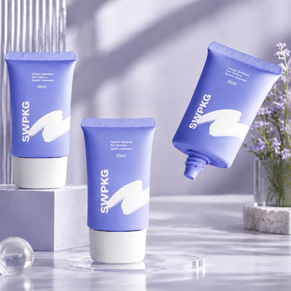 Blue cosmetic tubes with white caps for skincare products.