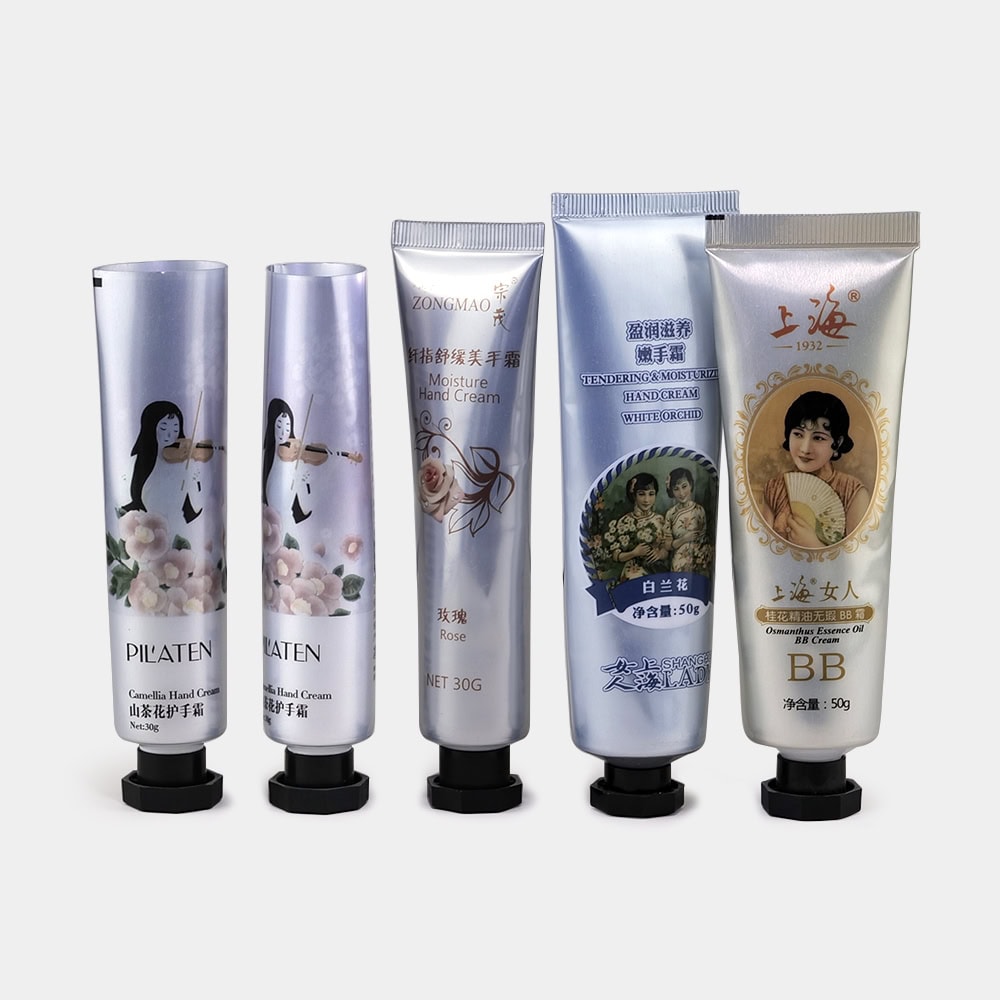 Assorted skincare tubes with floral and vintage designs for hand cream and sunscreen.